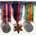 A Royal Navy WW2 medal group of three and a 1944 souvenir of Egypt embroidery