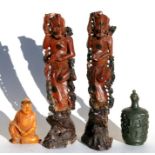 A Chinese amber coloured soapstone carving in the form of a robed figure holding a sceptre, 7cms (