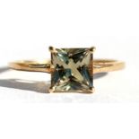 A 9ct gold dress ring set with a single square pale yellow stone, approx UK size 'Q'.