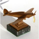 A brass model of the WW2 Supermarine Spitfire standing on a marble base. Wingspan 15.5cms (6.