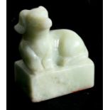 A Chinese jade seal in the form of a recumbent dog, 6cms (2.25ins) high.