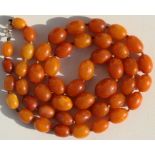 A dark butterscotch amber oval bead necklace, 96cms (37.8ins) long.Condition ReportWeight 99g, 47