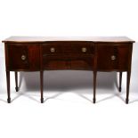A George III style mahogany concave fronted sideboard with a pair of central drawers flanked by a