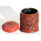 A Chinese cinnabar lacquer brush pot decorated with a dragon chasing a flaming pearl, 13cms (5ins)