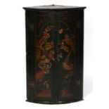 A 18th century chinoiserie lacquer bow fronted corner cupboard, 61cms (24ins) wide.