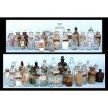 A large quantity of chemist or apothecary bottles, many etched or with remnants of labels (2