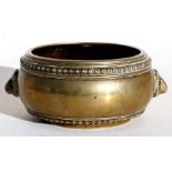 An 18th century Chinese bronze censer with beaded decoration and stylised handles, six-character