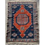 A Caucasian rug with central medallion within a geometric border on a blue ground, 97 by 134cms (