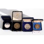 Four cased medallions including a 1974 silver Winston Churchill centenary with certificate and a