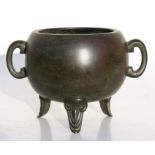 A Chinese bronze two-handled censer on tripod legs, with four-character mark to underside 12.5cms (