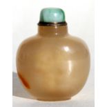 A Chinese carved agate snuff bottle with jadeite cover, 6.1cms (2.4ins) high.