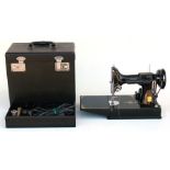 A Singer Featherweight portable sewing machine, (Catalogue CAK6-11), cased with accessories.
