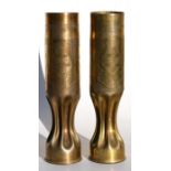 A matching pair of WW1 trench art fluted shell case vases elaborately decorated with the French