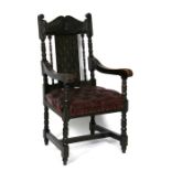 A Victorian oak carver chair with button upholstered seat and turned supports.