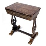 A 19th Chinese export lacquer sewing table on lyre shaped supports, the lift-up lid enclosing a