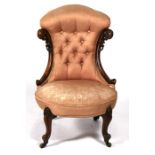 A Victorian walnut upholstered button back chair.