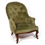 A Victorian button back armchair on cabriole front supports.