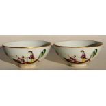 A pair of Chinese Qing dynasty tea bowls decorated with figures in boats on a sgraffito decorated