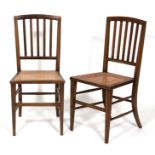 A pair of Heal & Son's walnut bedroom chairs with caned seats, on square tapering legs(2).