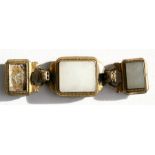 An 18th / 19th century Chinese gilt bronze three-part buckle with inset white jade panels and