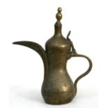 A Turkish / Islamic dallah coffee pot decorated with Islamic script, 28cms (11ins) high.