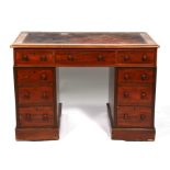 A late 19th century mahogany pedestal desk with an arrangement of nine drawers, on plinth base,