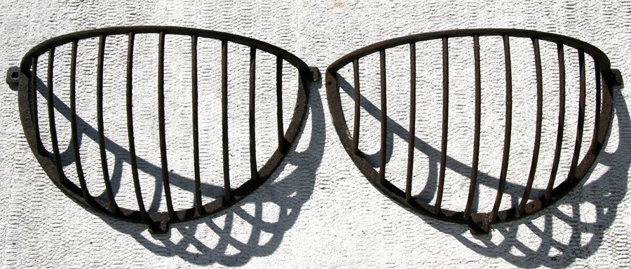 A pair of cast iron hay racks.