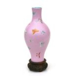 A Chinese vase decorated with butterflies on a pink sgraffito decorated ground, red seal mark to