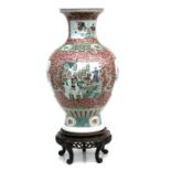 A large Chinese famille rose baluster vase on stand, decorated with figures, birds and flowers