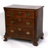 A Georgian walnut bachelor's chest with brushing slide over three long graduated drawers and blind