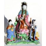 A 19th century Chinese famille rose group depicting Guanyin and Acolytes, 25cms (9.25ins) high.