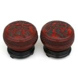 A pair of Chinese cinnabar lacquer boxes and covers on stands, of compressed globular form,