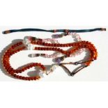 A Chinese Mandarin court amber bead necklace with three rock crystal divider beads and hardstone