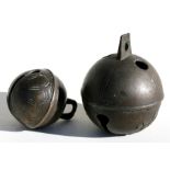 Two 19th century bronze Crotal or Rumbler bells, the largest decorated with applied flower sprays