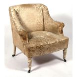 An Edwardian armchair on turned front supports.