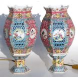 A pair of Chinese pierced table lamps of hexagonal form with panels decorated with birds and
