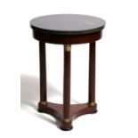 A French Empire style occasional table, the circular marble fossil top on turned supports and