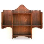 A Liberty & Co. oak wall mounted oak sectional wall shelf with enamel Liberty label to verso,