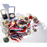 A tin of 30+ sport medals mainly for marathons