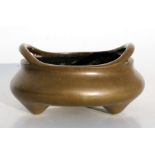 A Chinese bronze two-handled censer on three legs, with sixteen-character mark to underside,