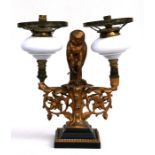 A gilt metal twin-arm oil lamp (converted to electricity) with central owl and it's prey perched