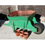 A late 19th / early 20th century green painted wooden wheelbarrow, 163cms (64ins) long; together