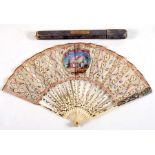 An 18th century ivory fan with central painted panel depicting a courting couple and a cherub with
