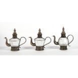 Three metal mounted Turkish glass coffee pots, 19.5cms (5.75ins) high.