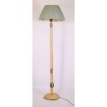 A brass mounted white painted standard lamp.