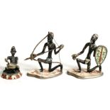 Three painted metal African figures, the largest 7cms (2.75ins) high.