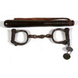A turned hardwood WPC truncheon with leather strap, 27cms (10.5ins) long; together with a pair of