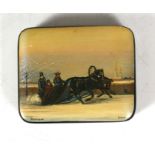 A Russian Fedoskino lacquered box decorated with figures in a horse drawn sleigh in a winter