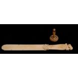A 19th century ivory letter opener, the handle surmounted with a crouched lion, 28cms (11ins)