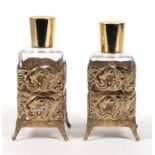 A pair of gilt metal mounted square scent bottles, 13cms (5ins) high.